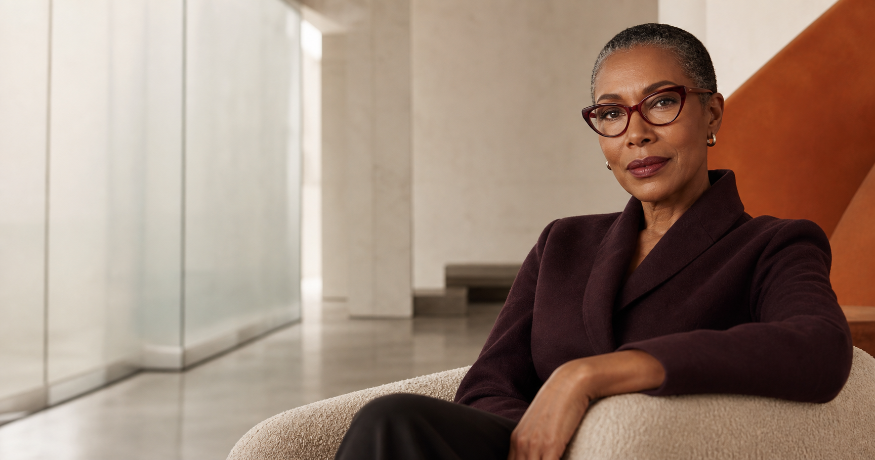 Woman wearing burgundy cat-eye glasses